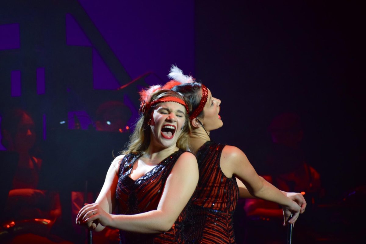 Seniors Carrie Willig (left) and Annie Renghini (right) singing "Nowadays" together for the finale.