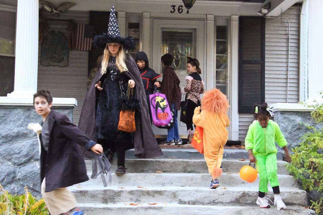 Trick-or-treaters knock on doors collecting candy as part of holiday tradition.