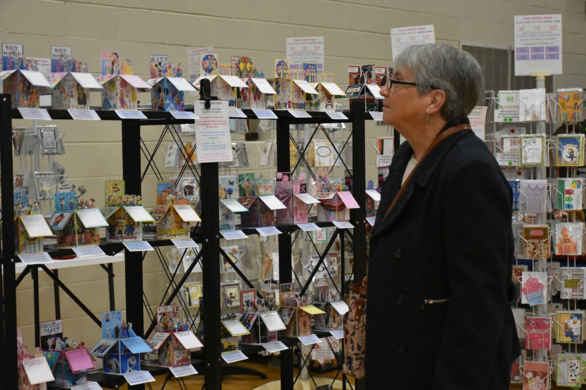 Woman browsing 3-D cut holiday cards.