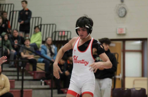 Senior Alex Gutierrez steps onto the mat for his key matchup.