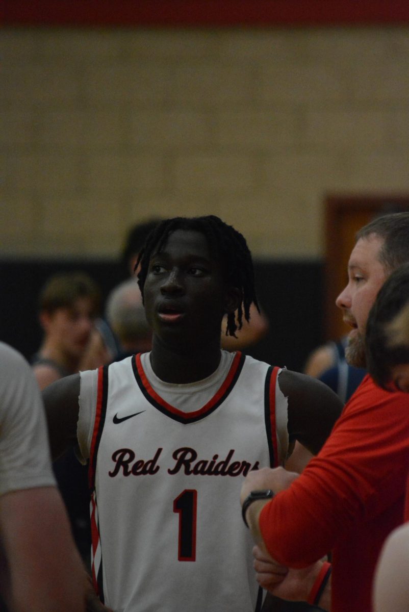 Assistant coach Chris Heward offering advice to senior Sheldon Bonsu.