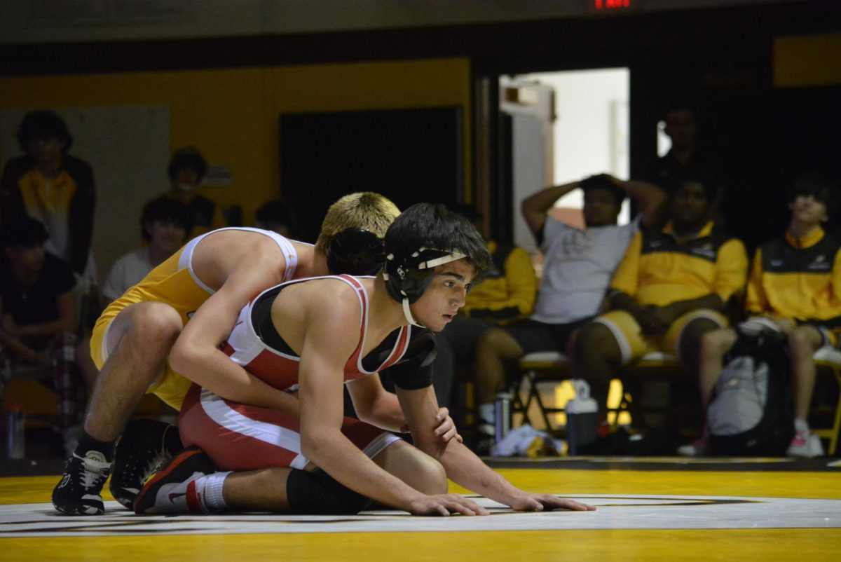 Alex Gutierrez sitting in the bottom position waiting for his opponent to make a move.