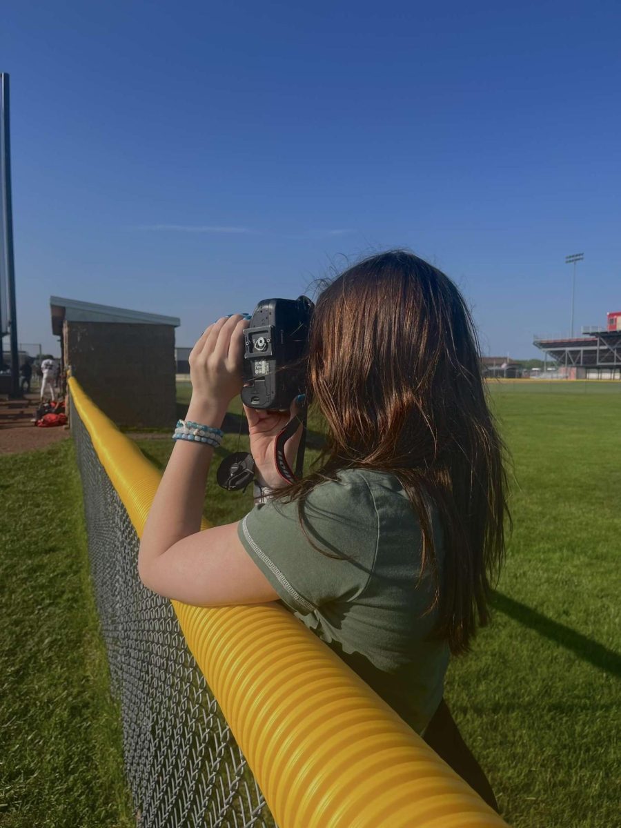 Coleman snaps a photo during a baseball game.