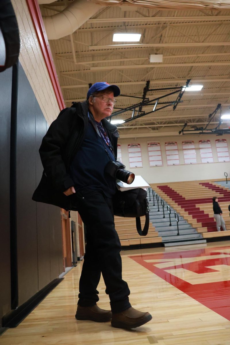 Huntley journalist and photographer Steve Peterson observing a game from the sidelines.