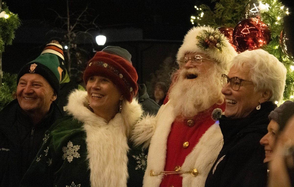 Santa Claus taking pictures with families and spreading holiday spirit. 

