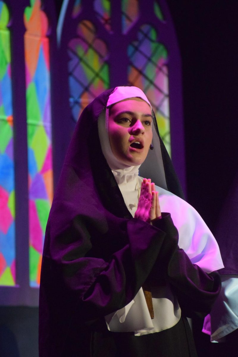 Olivia Rybicki as Sister Berthe. 