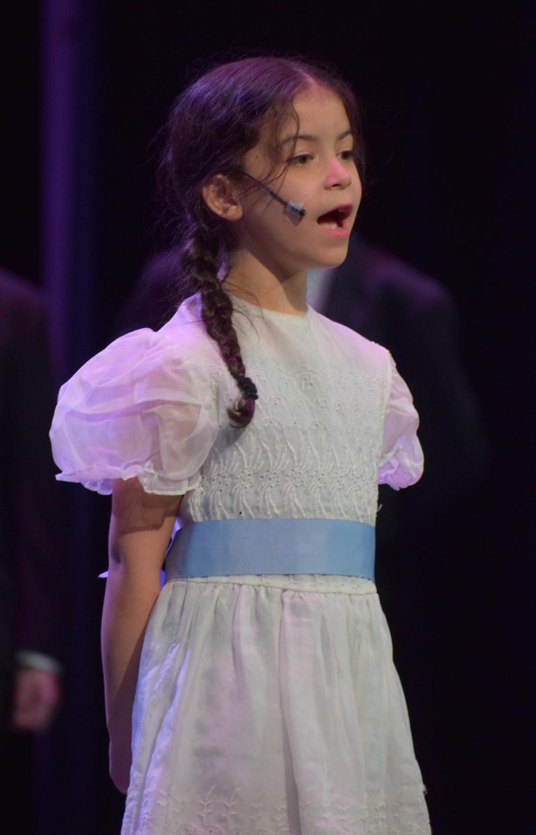 Gretl Von Trapp played by Grace Santiago singing "So Long, Farewell". 
