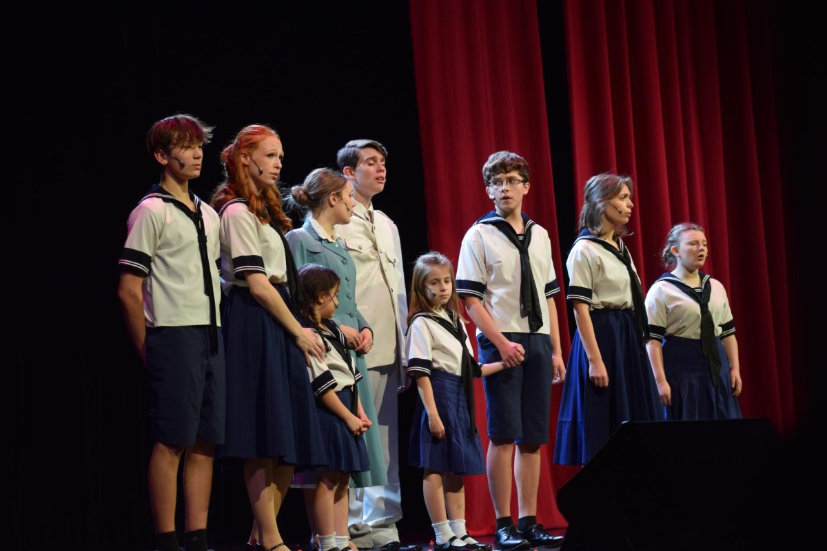 Captain and Maria Von Trapp with the children at a music festival singing "My Favorite Things". 