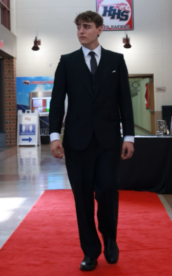 Parker DeSimone walking on the red carpet during the award ceremony for TV Production.