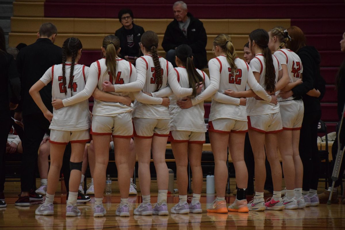 Varsity basketball in a huddle in the fourth quarter.