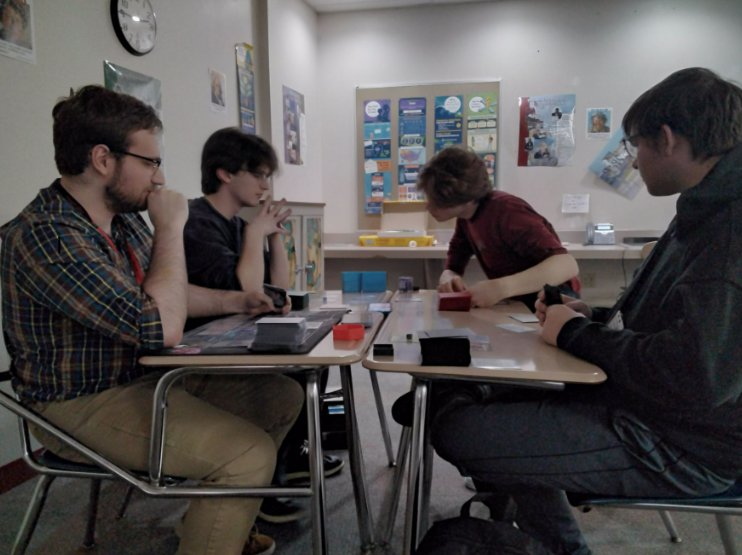 Students playing Magic: The Gathering with Mr. Herrington
