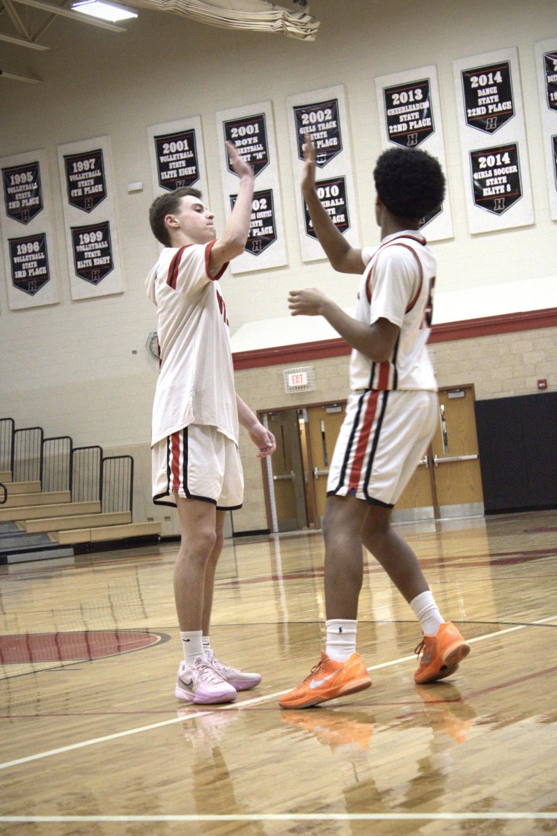 Number 10, Brady Hassels, doing a handshake with Muze.
