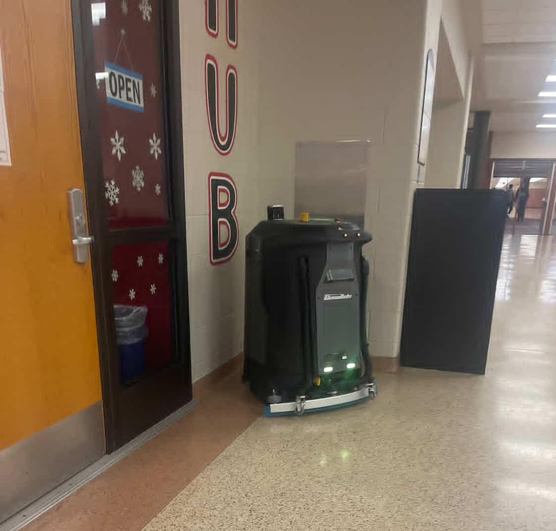 The cleaning robot on its trial run makes its way across the schools hallways. 