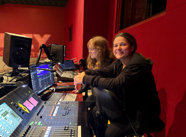 Leah Stech and Jill Dobek sit at the lightboard in the PAC.
