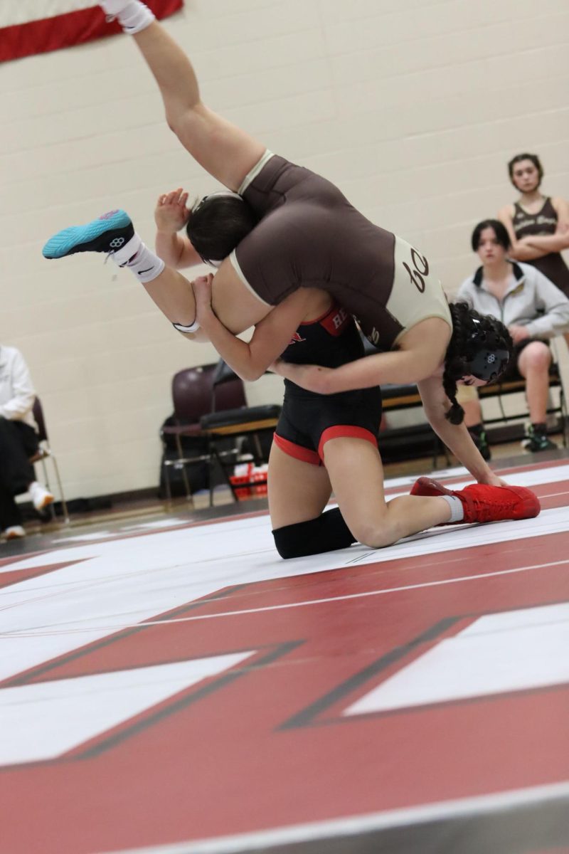 Singer taking down her opponent during a Huntley wrestling match