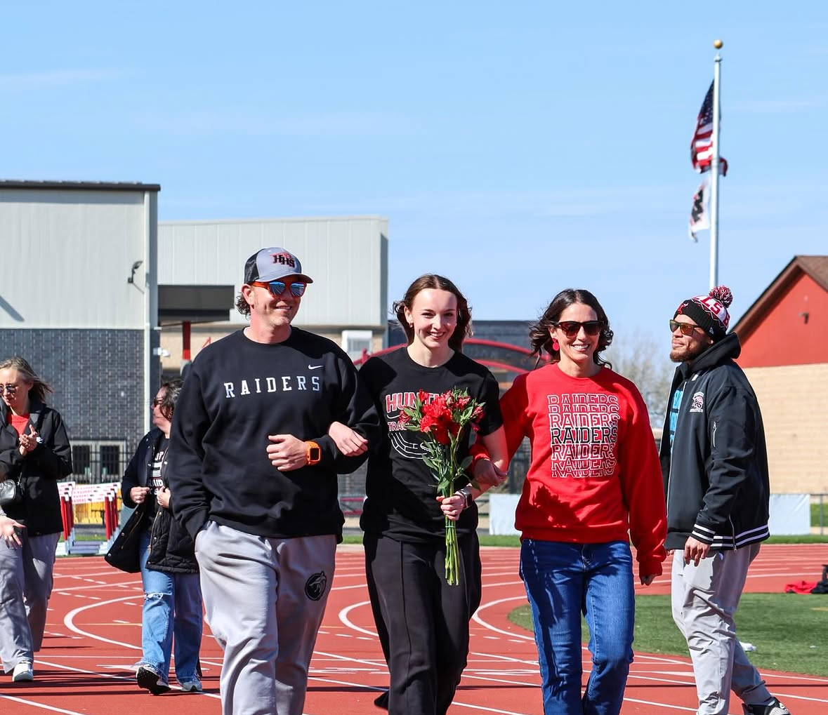 Senior Addison Busam walking across for her final recognition 